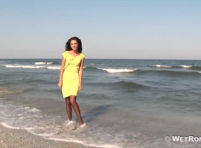 Despite the look, Antonia is not going to a cocktail party. Instead she wades straight into the sea, wearing a yellow dress, black sheer pantyhose and heels.
