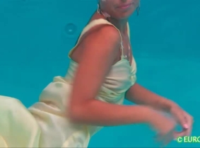 Judith is wearing a sexy nightgown and she is trying to hold her breath underwater as long as she can.