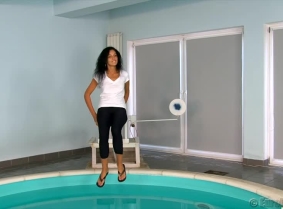 Alexandra is dunked for the first time. She is wearing a white t-shirt with no bra under, black leggings and a pair of flip-flops in a production originally made as a custom video production for a valued customer of custom-videos.com website.
