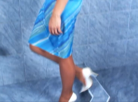 Maya is taking a sensual shower wearing her elegant blue dress, tan stockings and white pointy high heeled shoes.