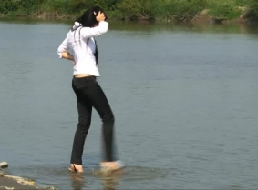 Another summer afternoon but the SAME way to cool off for Adria. She plays in the river wearing a pair of tight pants and a white shirt. Adria also wears high heeled sandals and no pantyhose in this one.